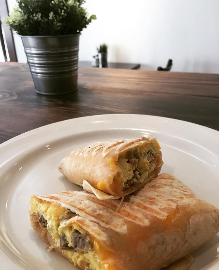 Breakfast burrito cut in half and served on a plate