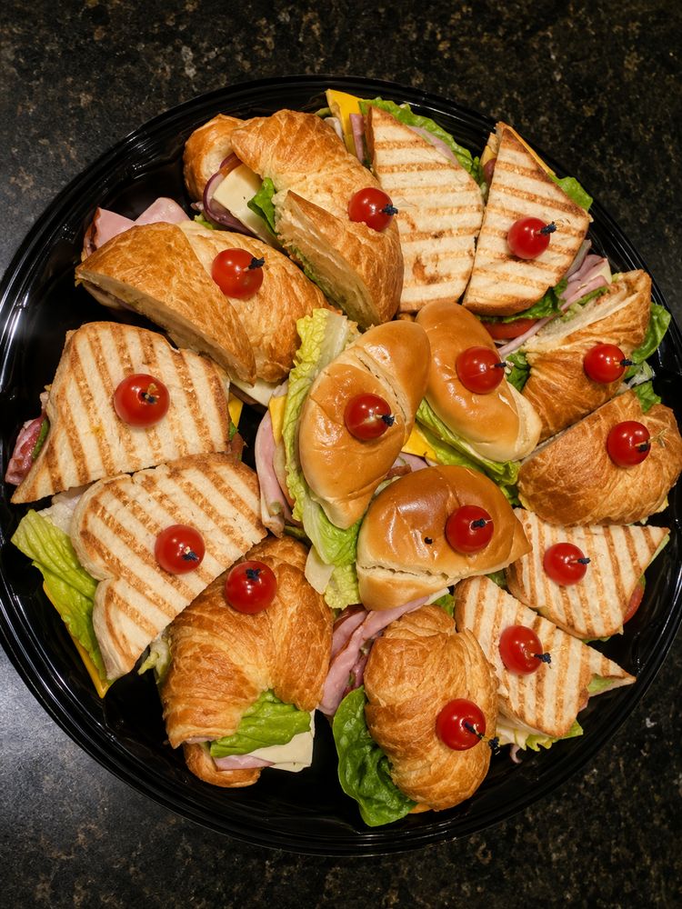 Platter of croissant sandwiches and grilled paninis