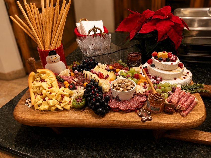 Holiday charcuterie board with cheeses, cured meats, fruit and nuts